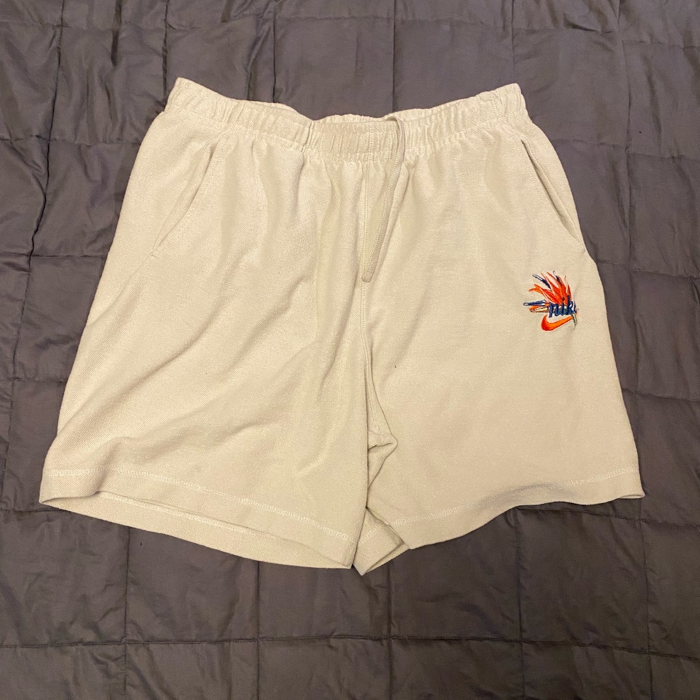 Nike Tan shorts with colorful logo